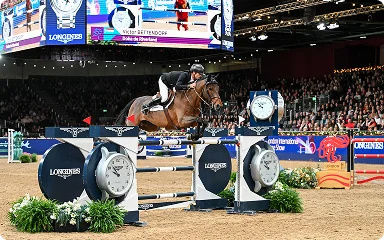 img - rider and horse leap over an equestrian jump